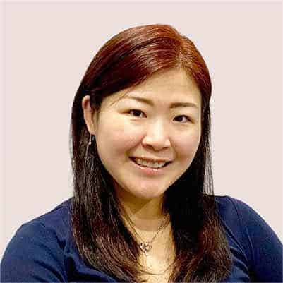 Professional woman with long brown hair smiling at the camera.