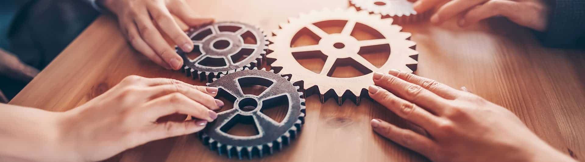 Teamwork and collaboration with gears symbolizing partnership and innovation.