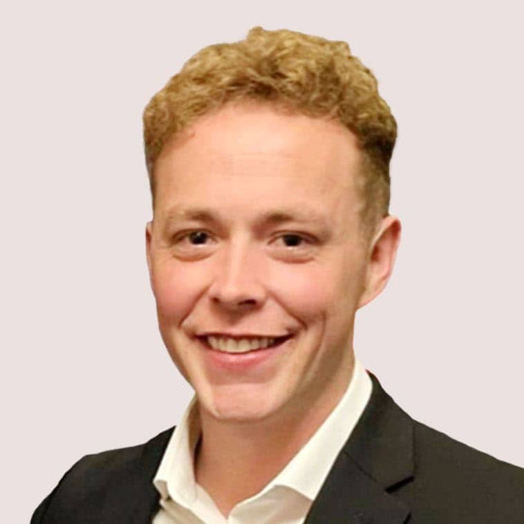 Professional portrait of a smiling man in a suit for GM & F Partners.